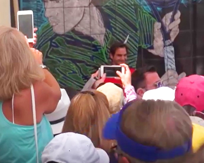 Fans capture photos of Roger Federer in front of the mural in Indian Wells, CA