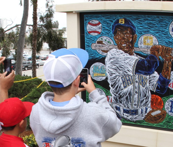 Fans and kids line up to photograph the Jackie Robinson Mural at JR Stadium