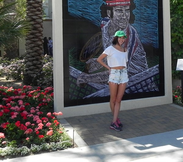 A tennis fan taking a photograph next to the John McEnroe Mural at the BNP Paribas Open