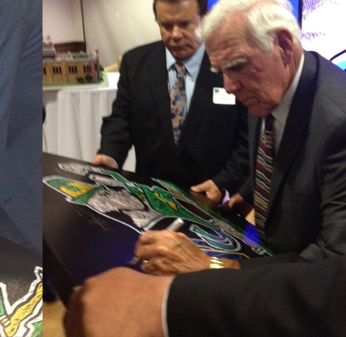 Notre Dame Legends Digger Phelps and Ara Parseghian signing the leprechaun giclee