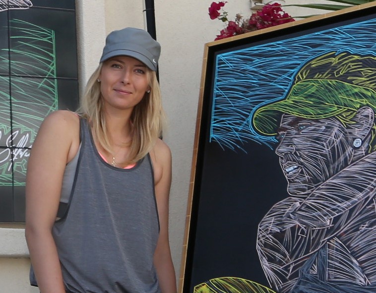 Maria Sharapova poses with the original canvas painting for the mural in Indian Wells, CA