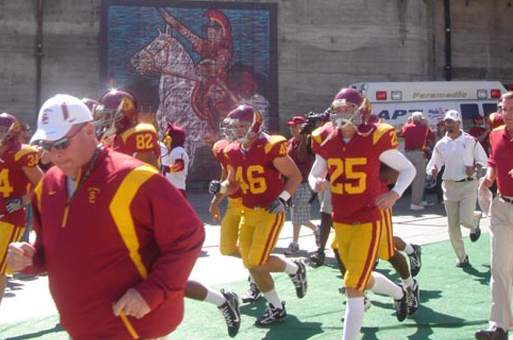 The USC football team takes the field in Los Angeles, CA at the Los Angeles Coliseum