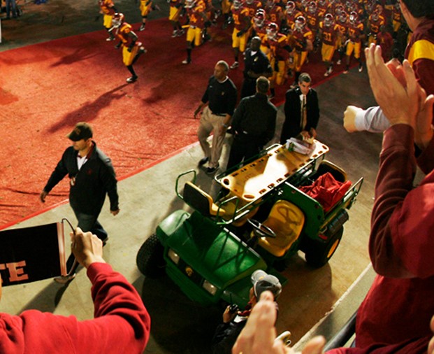 The USC football team takes the field at the Los Angeles Coliseum for a night game