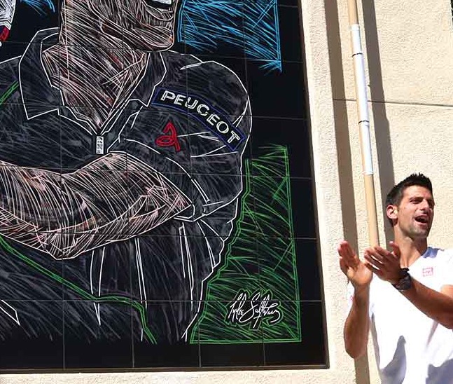 Novak Djokovic unveils his Championship Mural to the crowd and media watching