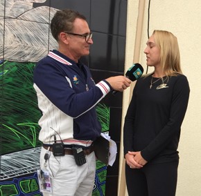 Elena Vesnina posing and being interviewed by her mural at the BNP Paribas Open